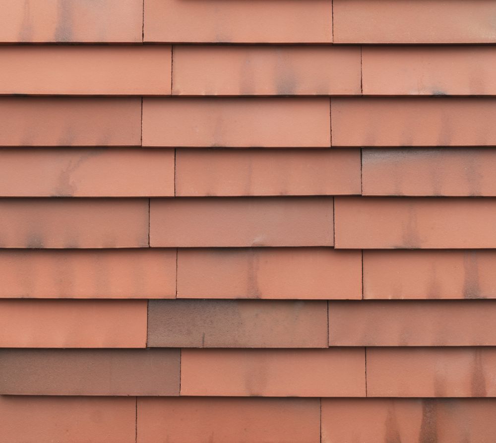 Terracotta-farbene vidra Ziegelfassade, zirkuläre