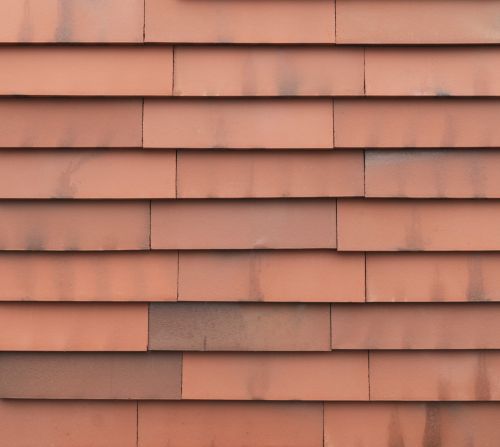 Terracotta-farbene vidra Ziegelfassade, zirkuläre